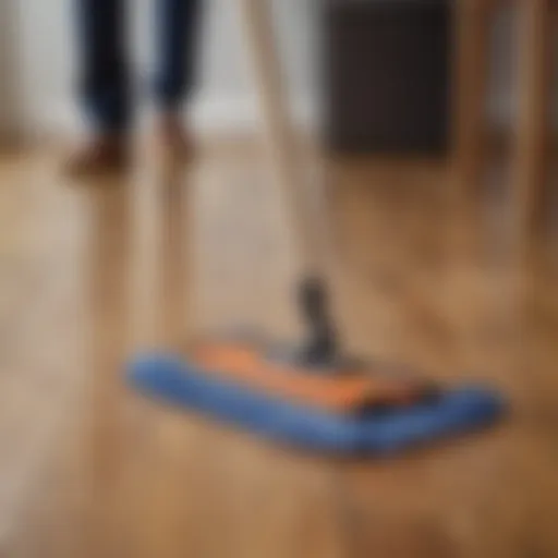 A person using a microfiber mop on a wooden floor