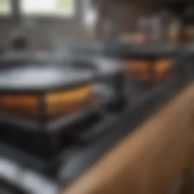 Close-up of a stovetop being cleaned with a soft cloth