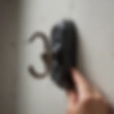 Close-up of a picture hook being mounted on the wall