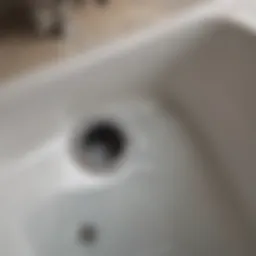 Clogged tub drain with water pooling around it